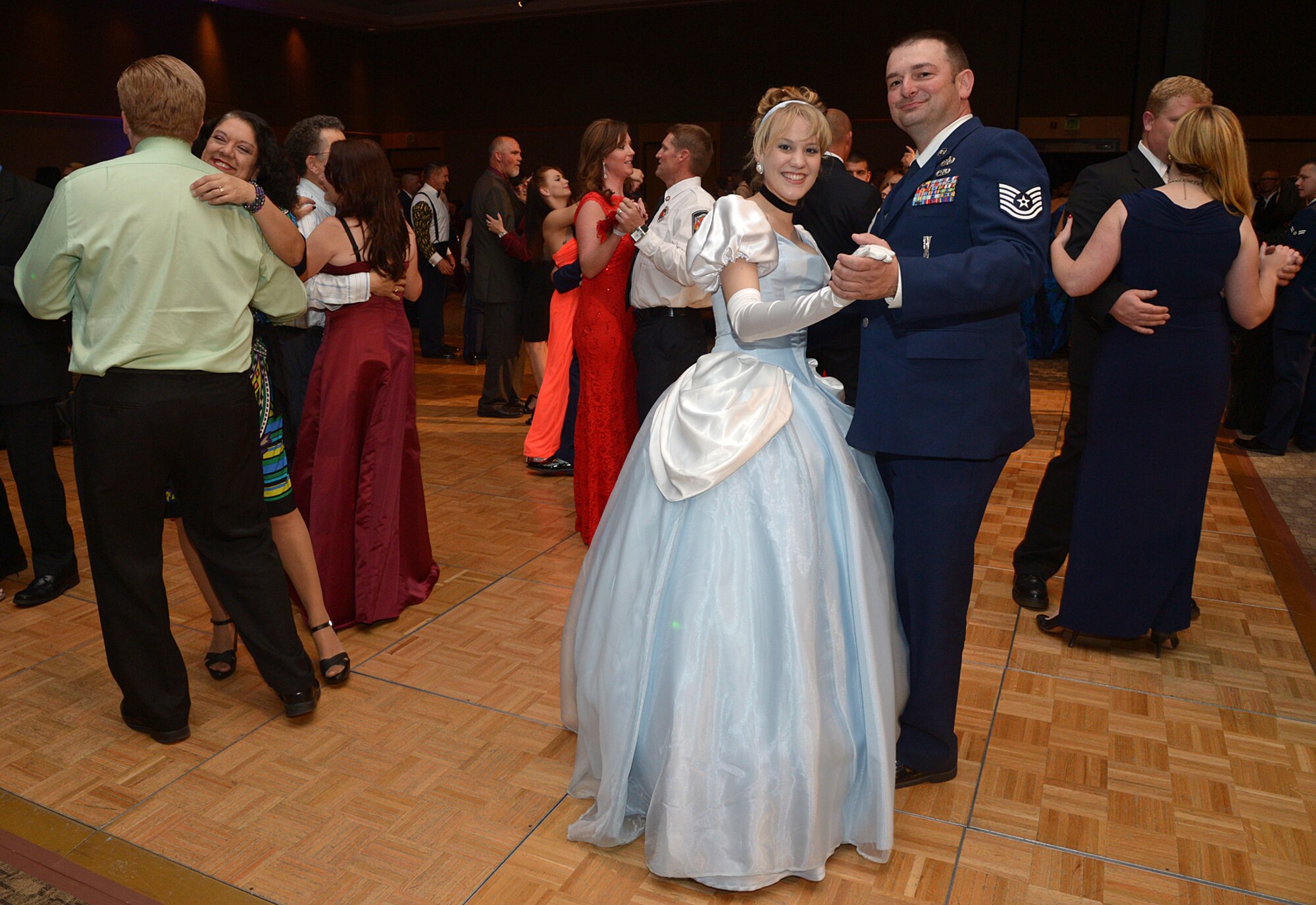 Ali Arbuckle, dressed as Cinderella, and her date retired Tech. Sgt. Rudolf Horak dance during the Hill Air Force Base 2015 Air Force Ball held Sept. 19 at the Eccles Conference Center in Ogden, Utah. Arbuckle dressed as Cinderella to raise support for a nonprofit group. (U.S. Air Force photo/Alex R. Lloyd)