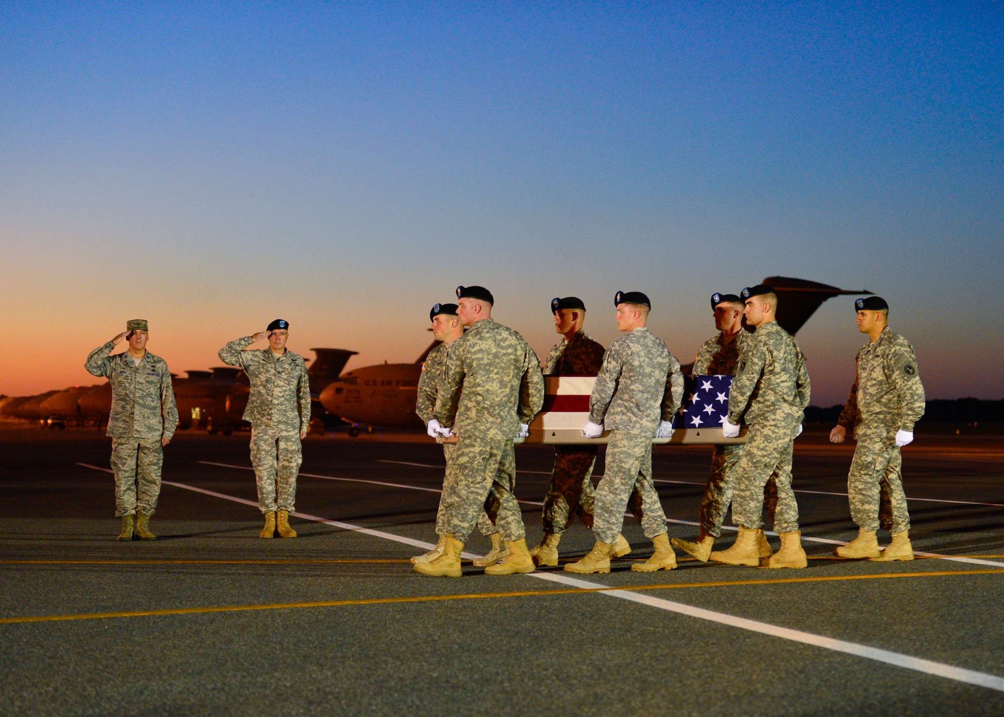 A U.S. Army carry team transfers the remains of Spc. Kyle E. Gilbert of Buford, Ga., at Dover Air Force Base, Del.  Buford was assigned to 2nd Battalion, 14th Infantry Regiment, 2nd Brigade Combat Team, 10th Mountain Division, Fort Drum, New York. (U.S. Air Force photo/Senior Airman William Johnson)  