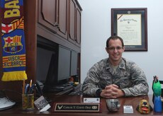 Capt. Carlos Cueto Diaz, 11th Wing assistant staff judge advocate, sits in his office Sept. 24, 2015, on Joint Base Andrews, Md. Cueto Diaz recently received the 2015 National Organization for Mexican American Rights Meritorious Service Award. (U.S. Air Force photo by Senior Airman Preston Webb) 