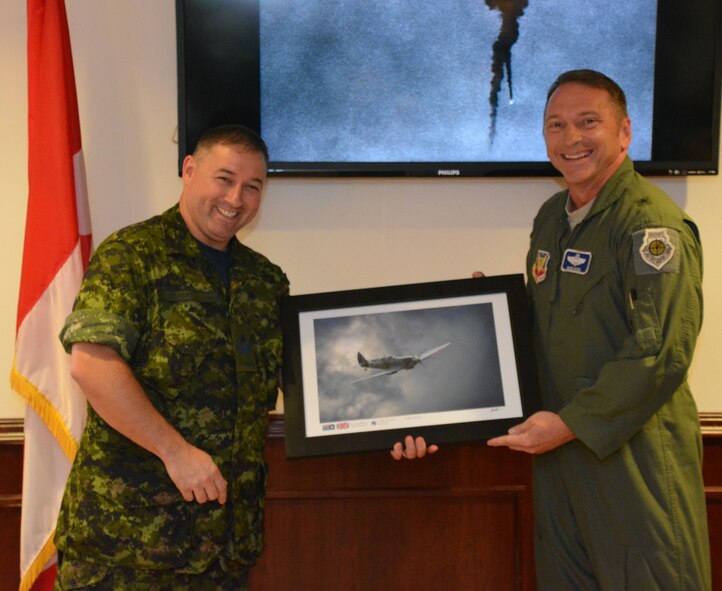 TYNDALL AIR FORCE BASE, Fla. – Royal Canadian Air Force Detachment Sgt. Jean-Francois Parent, President  of the Canadian Mess, received a commemorative print of a Spitfire aircraft from Brig. Gen. David Hicks, 1st Air Force (Air Forces Northern) Vice Commander, during the Canadian Detachment’s Battle of Britain Remembrance Ceremony at the Mess Sept. 22. Hicks received the print from the Royal Canadian Air Force during the Canadian Airshow Sept. which Hicks attended Sept. 4-7 as the U.S. Air Force representative.