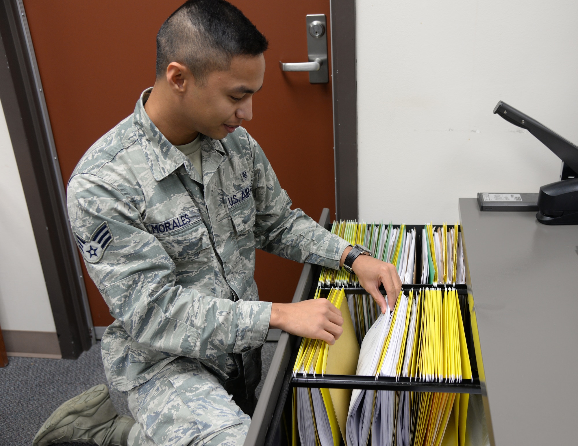 U.S. Air Force Senior Airman Noel Morales, a 354th Medical Support Squadron uniform business office manager, searches through vouchers Sept. 23, 2015, at Eielson Air Force Base, Alaska. Morales files collection vouchers and deposit slips that are kept for audit purposes. (U.S. Air Force photo by Airman 1st Class Cassandra Whitman/Released)