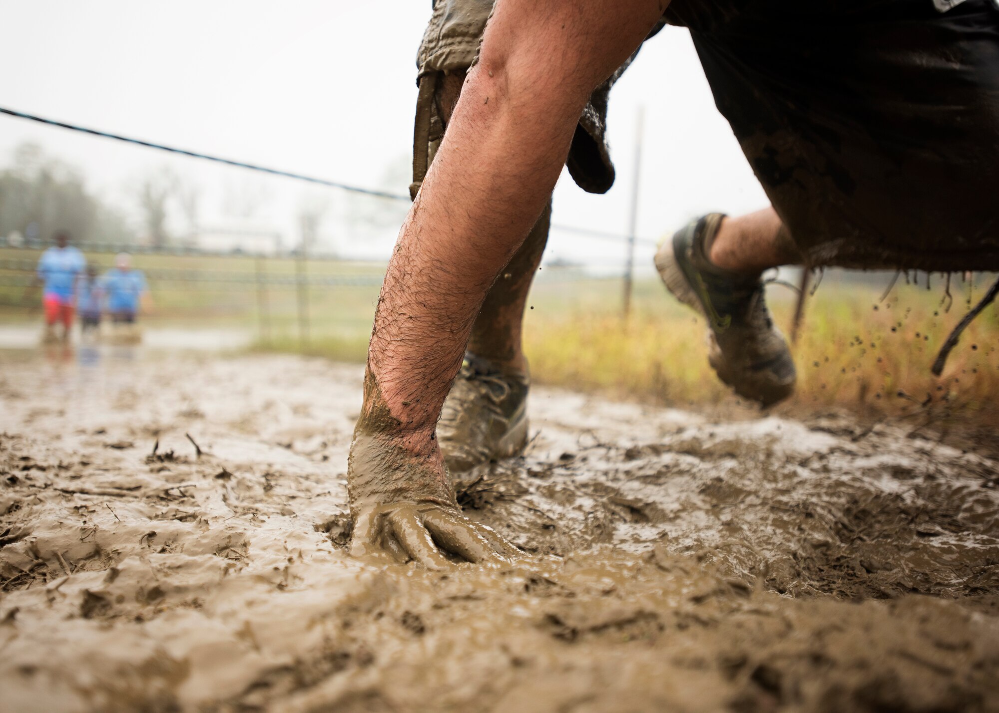 A runner crawls through mud during the 2015 “Beast of the East”Mud Run held Sept. 19, 2015 at Joint Base McGuire-Dix-Lakehurst, New Jersey. Runners had to crawl, swim, jump and climb over 20 obstacles along the course which included several mud pits and ponds; a tire flip; a ropes course; foam; climbing walls and many more. (U.S. Air Force photo by Staff Sgt. Katherine Tereyama) 
