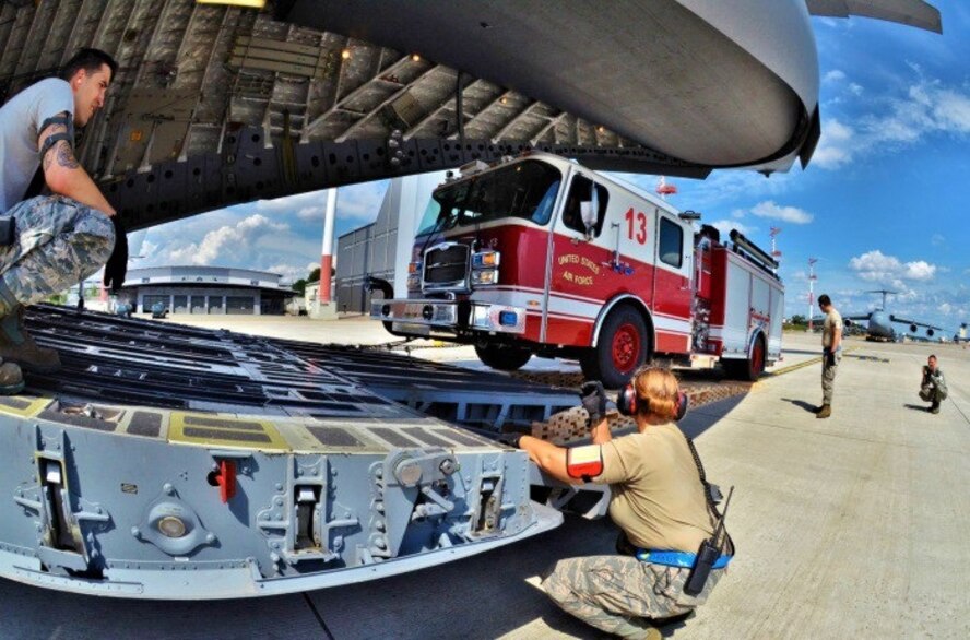 SSgt Justin Wirley and TSgt Krystle Lindamood perform spotting functions during fire engine upload in support of the presidential visit to Africa. (Courtesy Photo by Capt Jose A. Quintanilla)