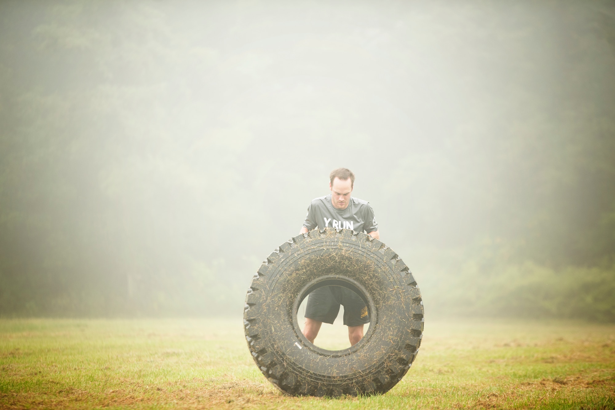A runner flips a tire during the 2015 “Beast of the East”Mud Run held Sept. 19, 2015 at Joint Base McGuire-Dix-Lakehurst, New Jersey. Runners had to crawl, swim, jump and climb over 20 obstacles along the course which included several mud pits and ponds; a tire flip; a ropes course; foam; climbing walls and many more. (U.S. Air Force photo by Staff Sgt. Katherine Tereyama)