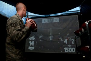 A U.S. Air Force Airman participates in the quarterback challenge during the USAA Salute to Service Tour at Langley Air Force Base, Va., Sept. 17, 2015. Twenty-five U.S. Army officers founded USAA in 1922 after a decision to personally insure each other’s vehicles. (U.S. Air Force photo by Airmen 1st Class Derek Seifert/ Released)