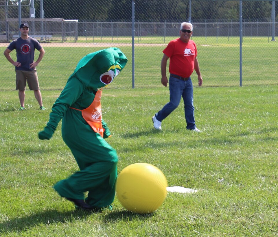 One of the top sports competitors in the unit, Senior Master Sgt. Ron Peterson (in red) from the 932nd Civil Engineering Squadron, watches "Gumby" the clay stop motion animation television character, prepare to kick the yellow ball at the recent 932nd Airlift Wing Family Picnic event.  Sunshine greeted the unit during the afternoon as the USO came out to help provide lunch and a variety of fun activities.  (U.S. Air Force photo by Maj. Stan Paregien)