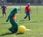 One of the top sports competitors in the unit, Senior Master Sgt. Ron Peterson (in red) from the 932nd Civil Engineering Squadron, watches "Gumby" the clay stop motion animation television character, prepare to kick the yellow ball at the recent 932nd Airlift Wing Family Picnic event.  Sunshine greeted the unit during the afternoon as the USO came out to help provide lunch and a variety of fun activities.  (U.S. Air Force photo by Maj. Stan Paregien)