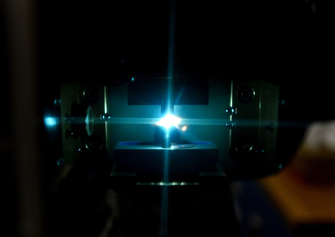 A slop oil sample burns inside of an optical emission spectrometer at Langley Air Force Base, Va., Sept. 22, 2015. The spectrometer detects increases in the oil’s wear metal content, ultimately predicting the location of aircraft component failure. (U.S. Air Force photo by Senior Airman Aubrey White/Released)