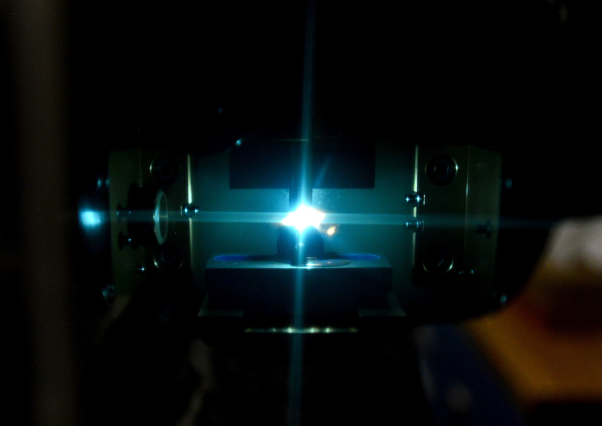 A slop oil sample burns inside of an optical emission spectrometer at Langley Air Force Base, Va., Sept. 22, 2015. The spectrometer detects increases in the oil’s wear metal content, ultimately predicting the location of aircraft component failure. (U.S. Air Force photo by Senior Airman Aubrey White/Released)
