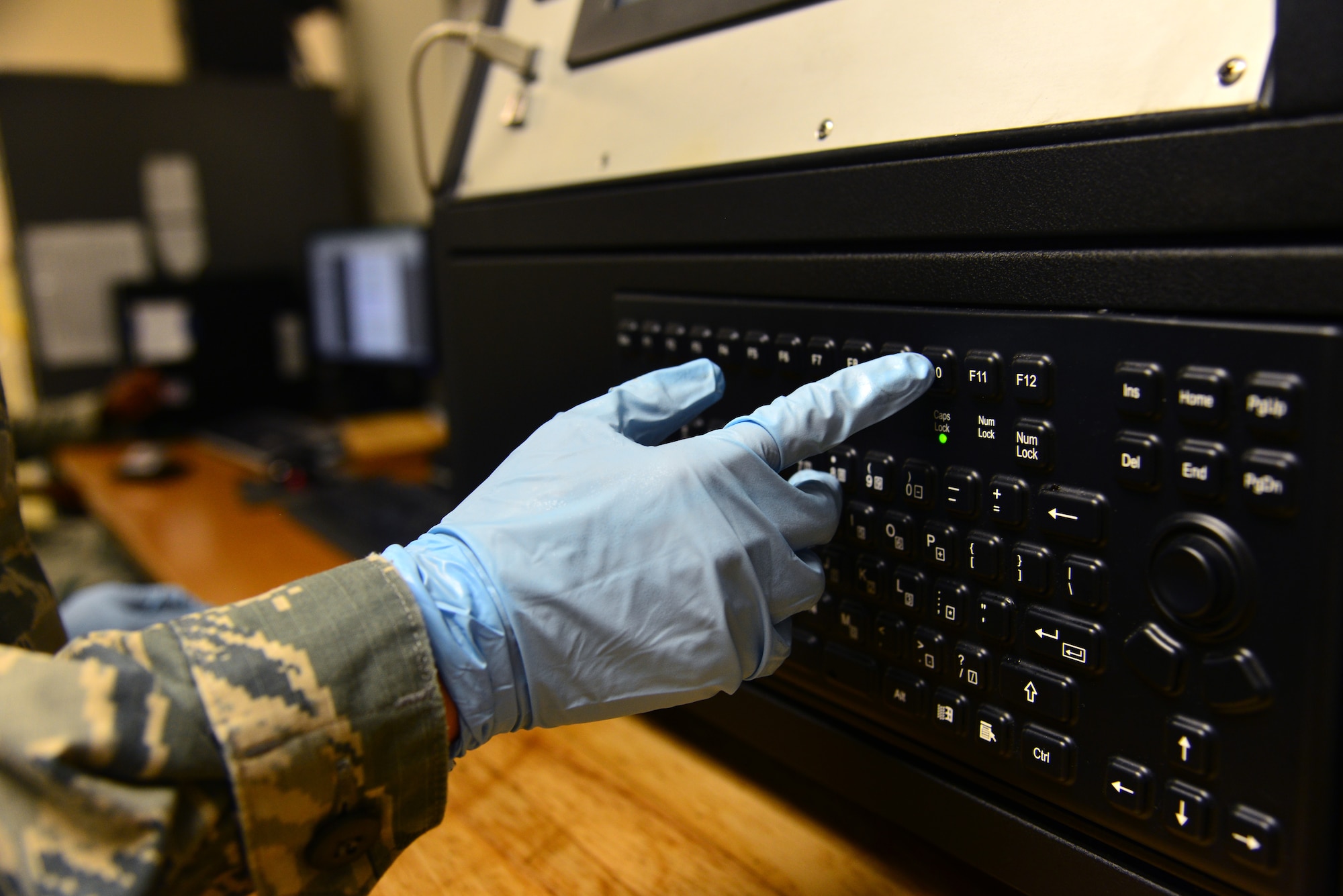 A U.S. Air Force non-destructive inspection apprentice assigned to the 1st Maintenance Squadron clears data on an optical emission spectrometer before analyzing aircraft oil at Langley Air Force Base, Va., Sept. 22, 2015. The spectrometer computer analyzes the intensity of light and colors emitted by burning aircraft oil to determine the type of metallic elements contained in the oil. (U.S. Air Force photo by Senior Airman Aubrey White/Released)