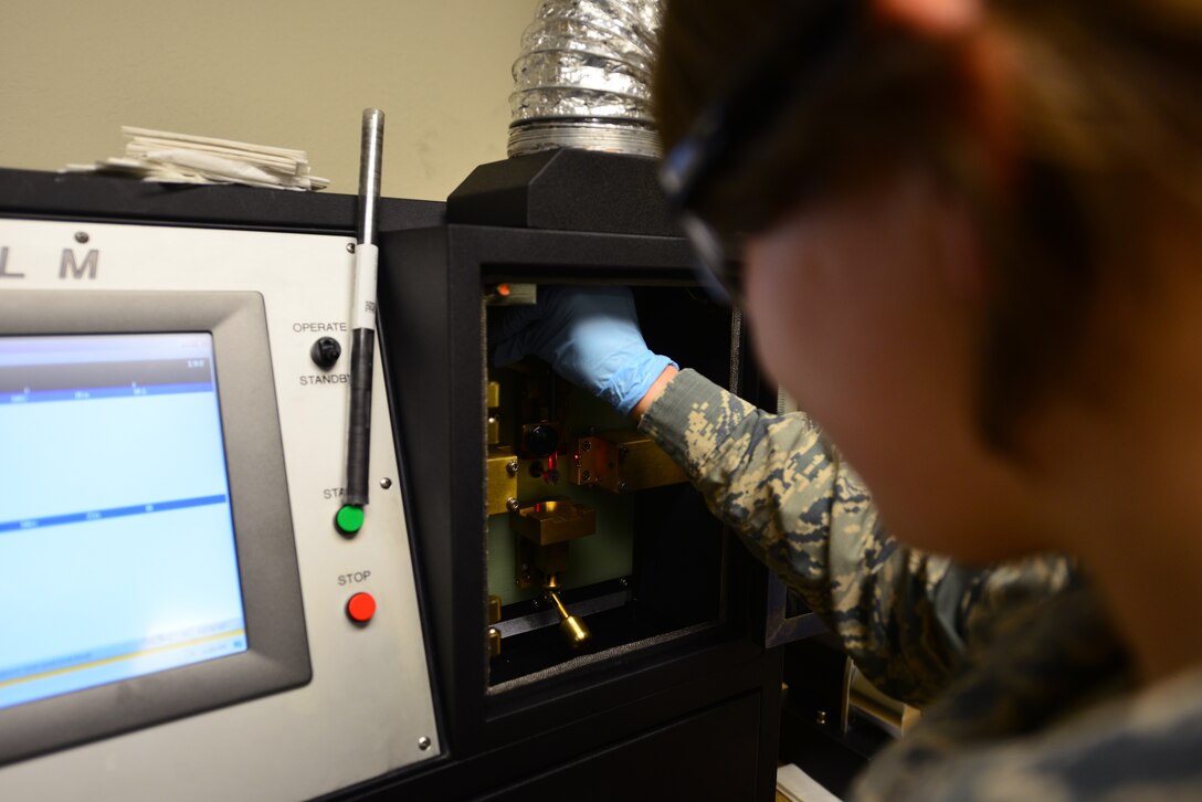U.S. Air Force Airman 1st Class Emily Anderson, 1st Maintenance Squadron non-destructive inspection apprentice, prepares an optical emission spectrometer before analyzing aircraft oil at Langley Air Force Base, Va., Sept. 22, 2015. According to its manufacturer, the machine is a compact, rugged, transportable spectrometer designed to analyze wear metals, contaminants and additives in lubricants, hydraulic fluids and coolants. (U.S. Air Force photo by Senior Airman Aubrey White/Released)