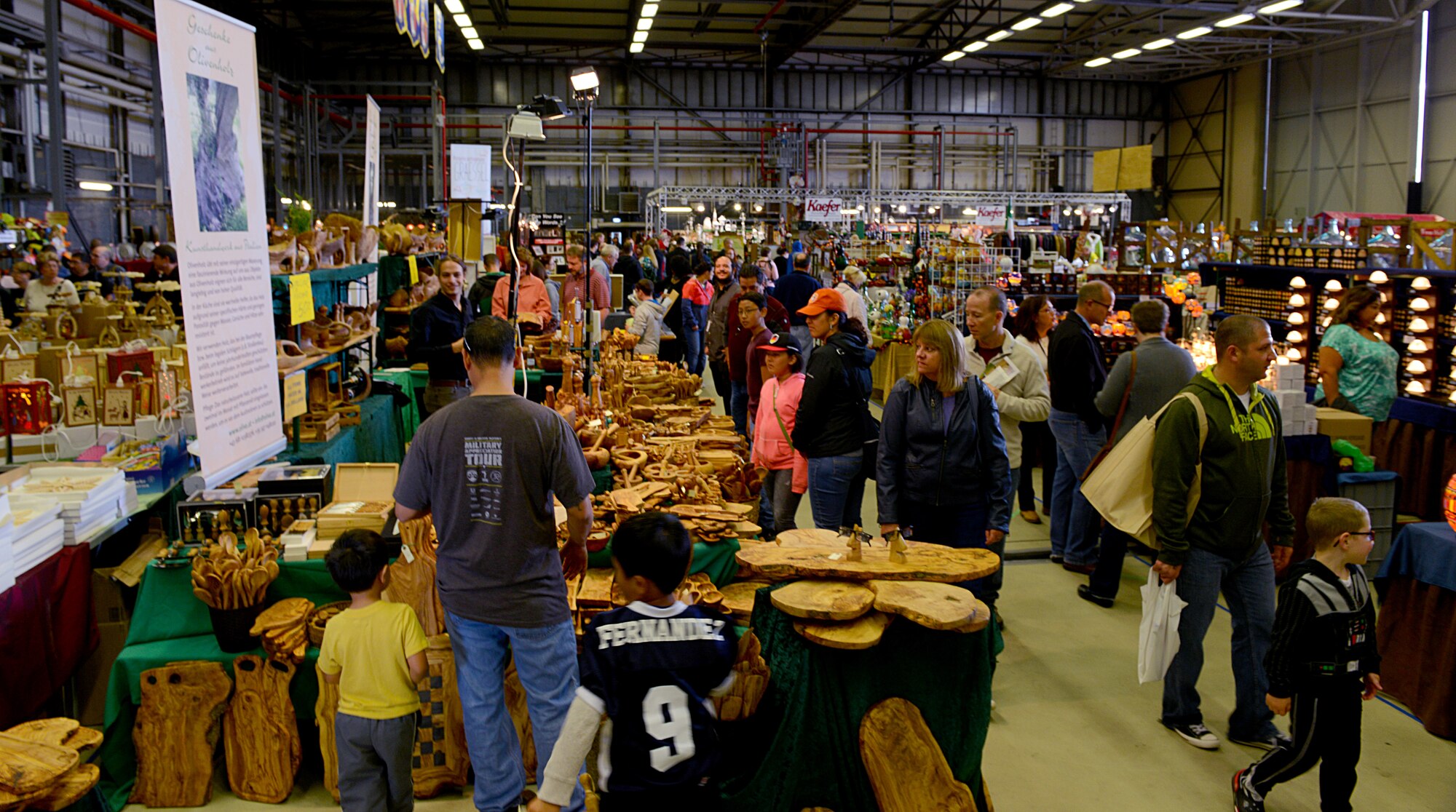 Patrons of the 51st Ramstein Bazaar peruse merchandise Sept. 19, 2015, at Ramstein Air Base, Germany. The bazaar is an 86th Force Support Squadron event. (U.S. Air Force photo/Senior Airman Timothy Moore)