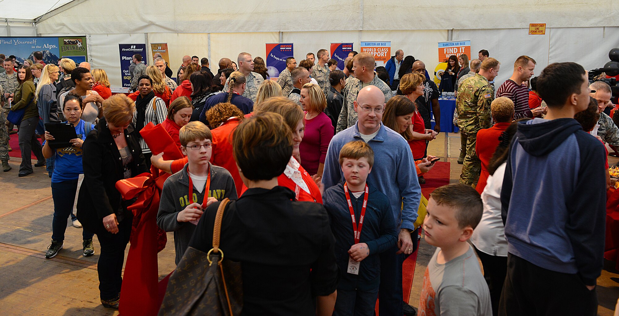 Attendees of the 51st Ramstein Bazaar red carpet event mingle with each other Sept. 16, 2015, at Ramstein Air Base, Germany. The event included a ribbon-cutting ceremony, which officially opened the bazaar, and was held so the more than 200 Ramstein Bazaar volunteers could take a look at the products on sale beforehand. (U.S. Air Force photo/Senior Airman Timothy Moore)