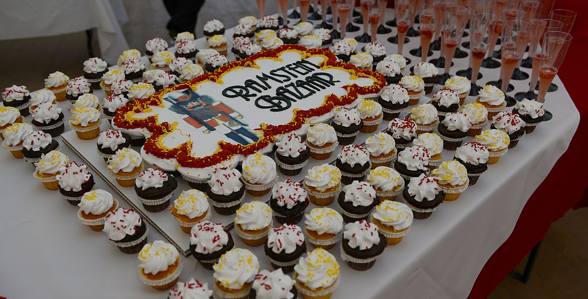 A cake and cupcakes are displayed on a table during the 51st Ramstein Bazaar red carpet event Sept. 16, 2015, at Ramstein Air Base, Germany. The event included a ribbon-cutting ceremony, which officially opened the bazaar. (U.S. Air Force photo/Senior Airman Timothy Moore)
