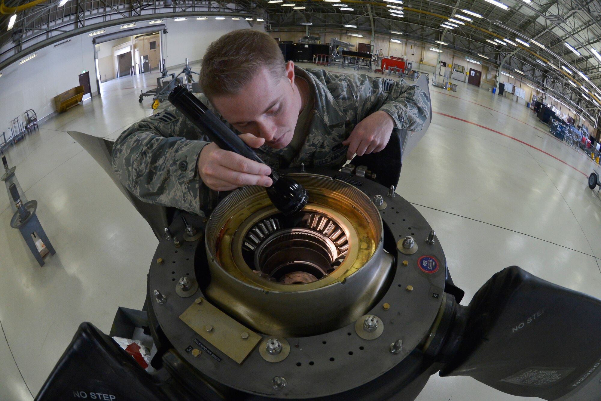 Senior Airman Colton Windsor, 374th Maintenance Squadron propulsion flight aerospace propulsion journeyman, inspects the blade teeth of the propeller at Yokota Air Base, Japan, Sept. 23, 2015. In addition to providing support for both Yokota and Kadena Air Base, the flight provides engine and propeller support for all active duty, guard and reserve C-130s tasked within their area of responsibility. (U.S. Air Force photo by Senior Airman David Owsianka/Released)