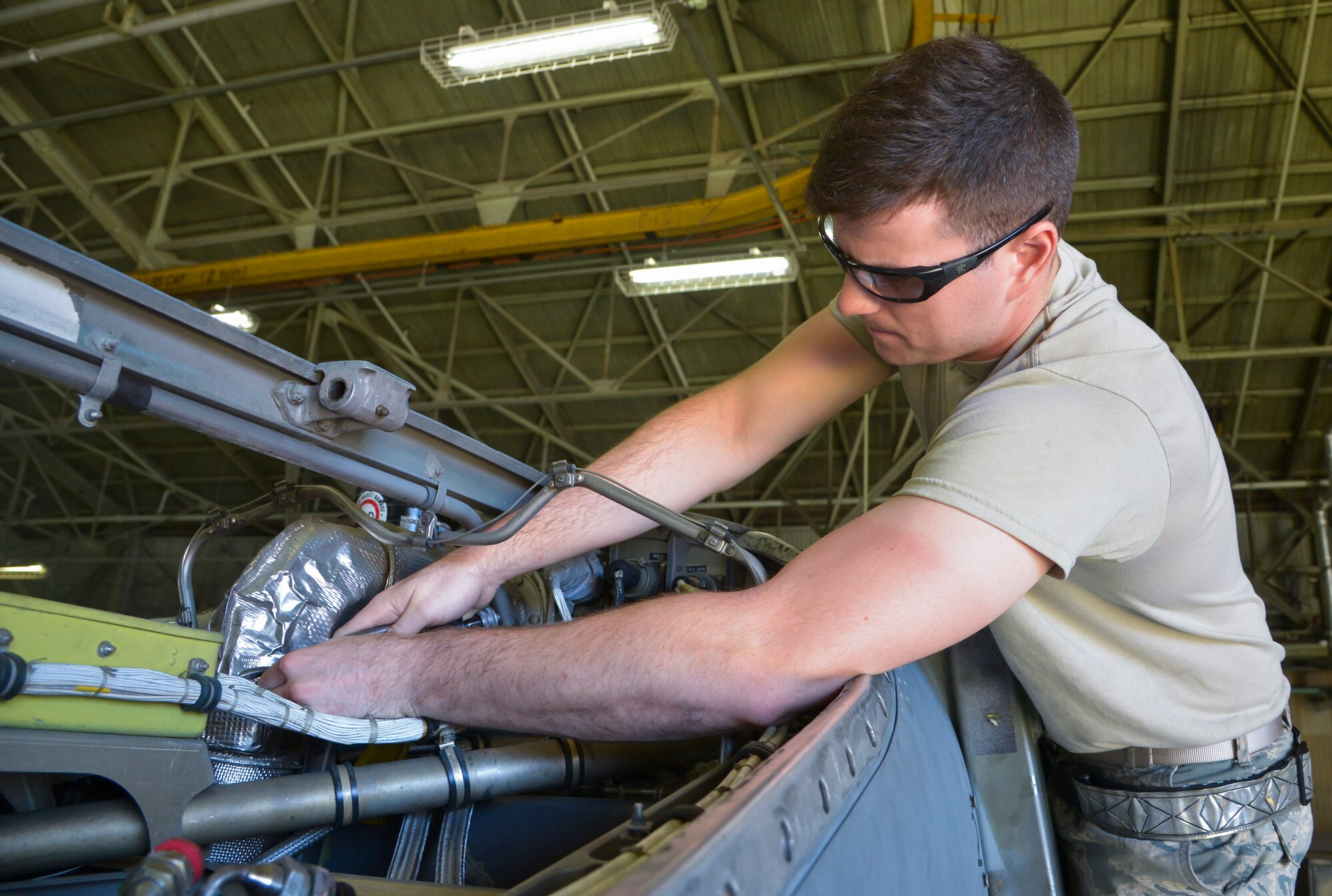 Airman Sam Johnson, 374th Maintenance Squadron propulsion flight aerospace propulsion apprentice, removes safety wires from a heat blanket inside a C-130 Hercules at Yokota Air Base, Japan, Sept. 23, 2015. After an engine or propeller is repaired by the flight, they will wait for the proper moment to be placed into action. (U.S. Air Force photo by Senior Airman David Owsianka/Released)