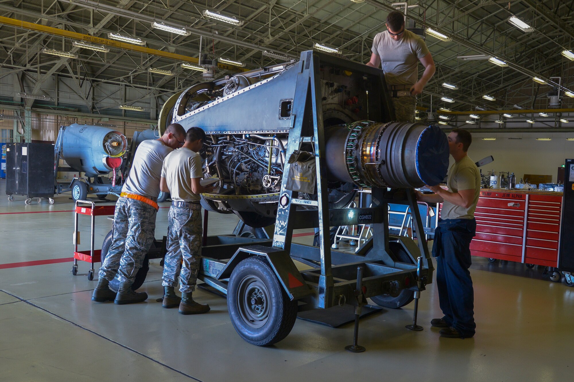 Airmen with the 374th Maintenance Squadron propulsion flight inspect an engine prior to going through an operational check in the test cell at Yokota Air Base, Japan, Sept. 23, 2015. The jet engine intermediate maintenance section performs routine maintenance work on the engines and rebuilds them when necessary. (U.S. Air Force photo by Senior Airman David Owsianka/Released)