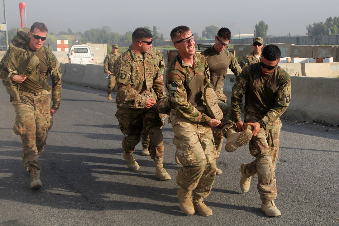 U.S. soldiers evacuate a simulated casualty during the physical fitness portion of their air assault training on Jalalabad Airfield in eastern Afghanistan, Sept. 16, 2015. U.S. Army photo by Capt. Charles Emmons