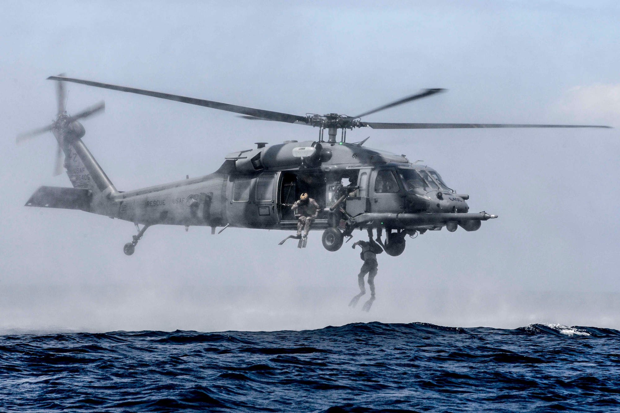 Airmen from the 320th Special Tactics Squadron, Kadena Air Base, perform a helo-casting jump out of a U.S. Air Force HH-60G Pave Hawk from the 33rd Rescue Squadron during an amphibious operations exercise Sept. 22, 2015, off the West Coast of Okinawa, Japan. Team members are qualified in non-standard methods of infiltration to include, static line, military freefall, and closed and open circuit diving. (U.S. Air Force photo by Senior Airman John Linzmeier)