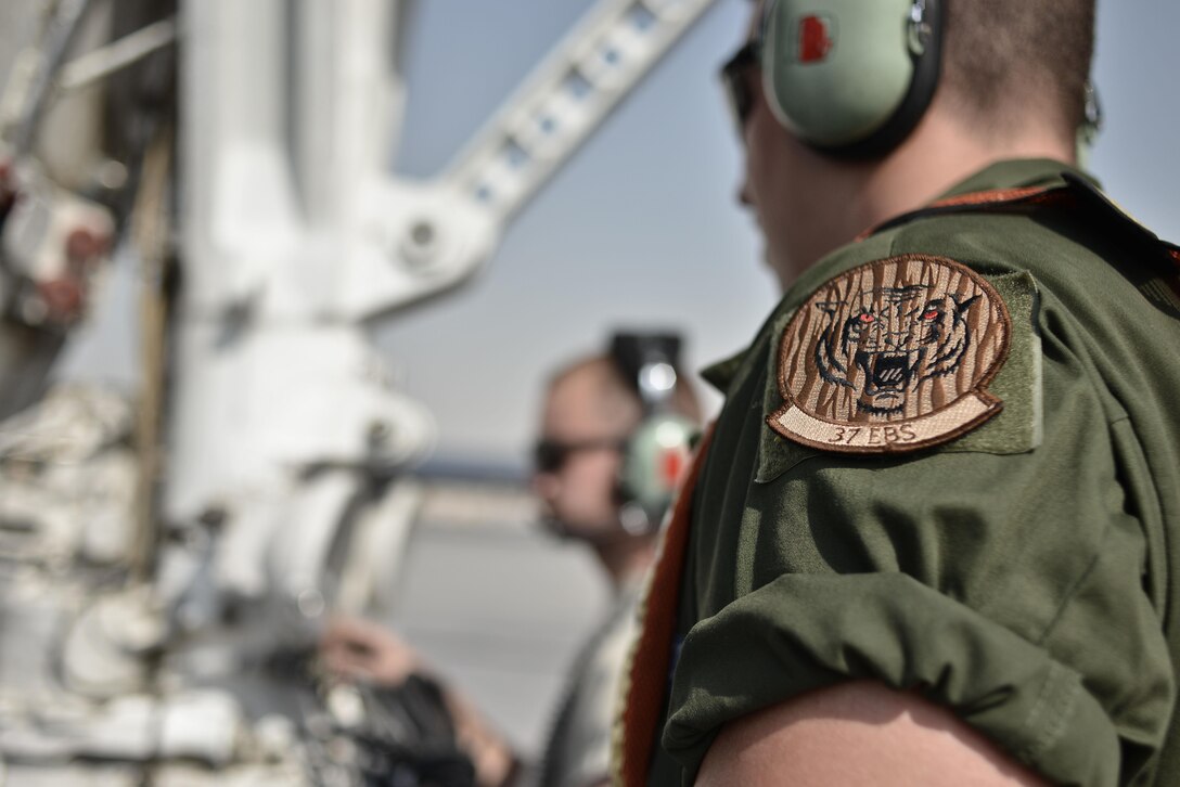Staff Sgt. Bryant Reinert, 37th Aircraft Maintenance Unit crew chief, waits for the 'ok' to marshal a B-1B Lancer out for take-off September 22, 2015 at Al Udeid Air Base, Qatar. Reinert is deployed out of Ellsworth Air Force Base, S.D.  (U.S. Air Force photo/Staff Sgt. Alexandre Montes)