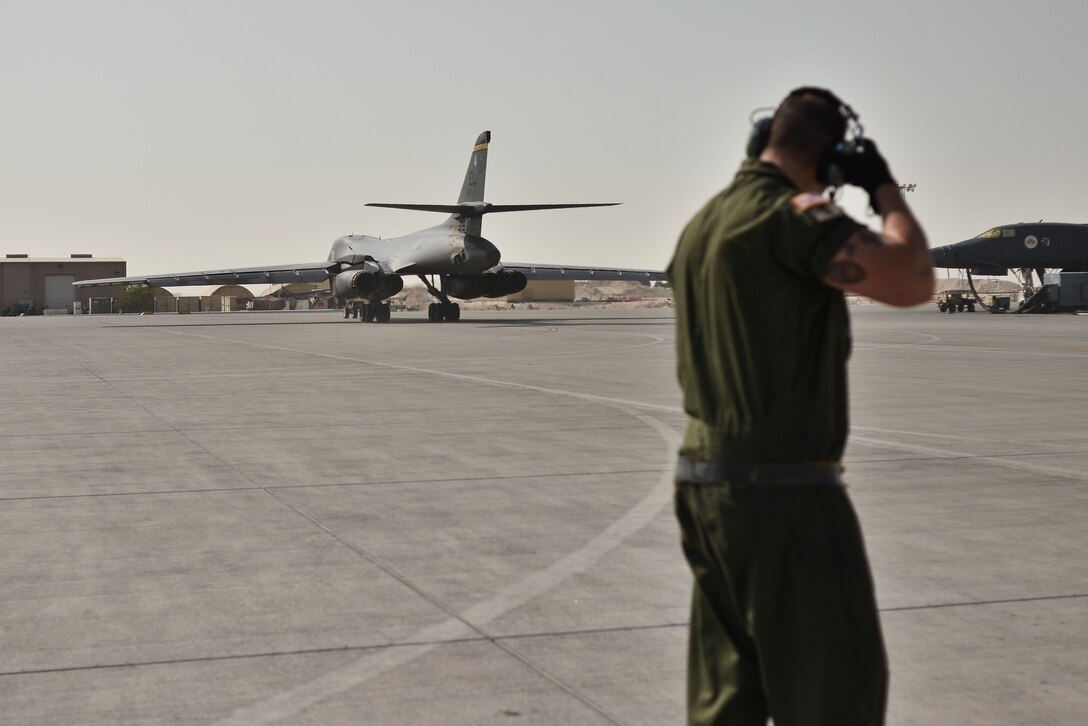 Staff Sgt. Bryant Reinert, 37th Aircraft Maintenance Unit crew chief, watches as his B-1B Lancer moves towards the flightline for take-off September 22, 2015 at Al Udeid Air Base, Qatar. Reinert is deployed out of Ellsworth Air Force Base, S.D. (U.S. Air Force photo/Staff Sgt. Alexandre Montes)