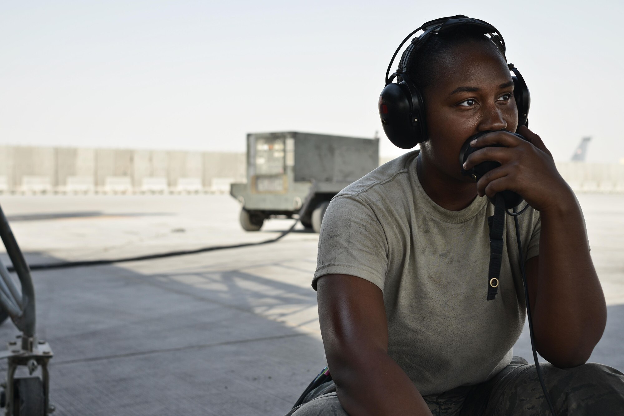 Airman 1st Class Sade Wilkins, 37th Aircraft Maintenance Unit crew chief, listens to another crew chief inside a B1-B lancer while completing operation checks during post-flight inspections September 22, 2015 at Al Udeid Air Base, Qatar. Wilkins is deployed out of Ellsworth Air Force Base, S.D. (U.S. Air Force photo/Staff Sgt. Alexandre Montes)