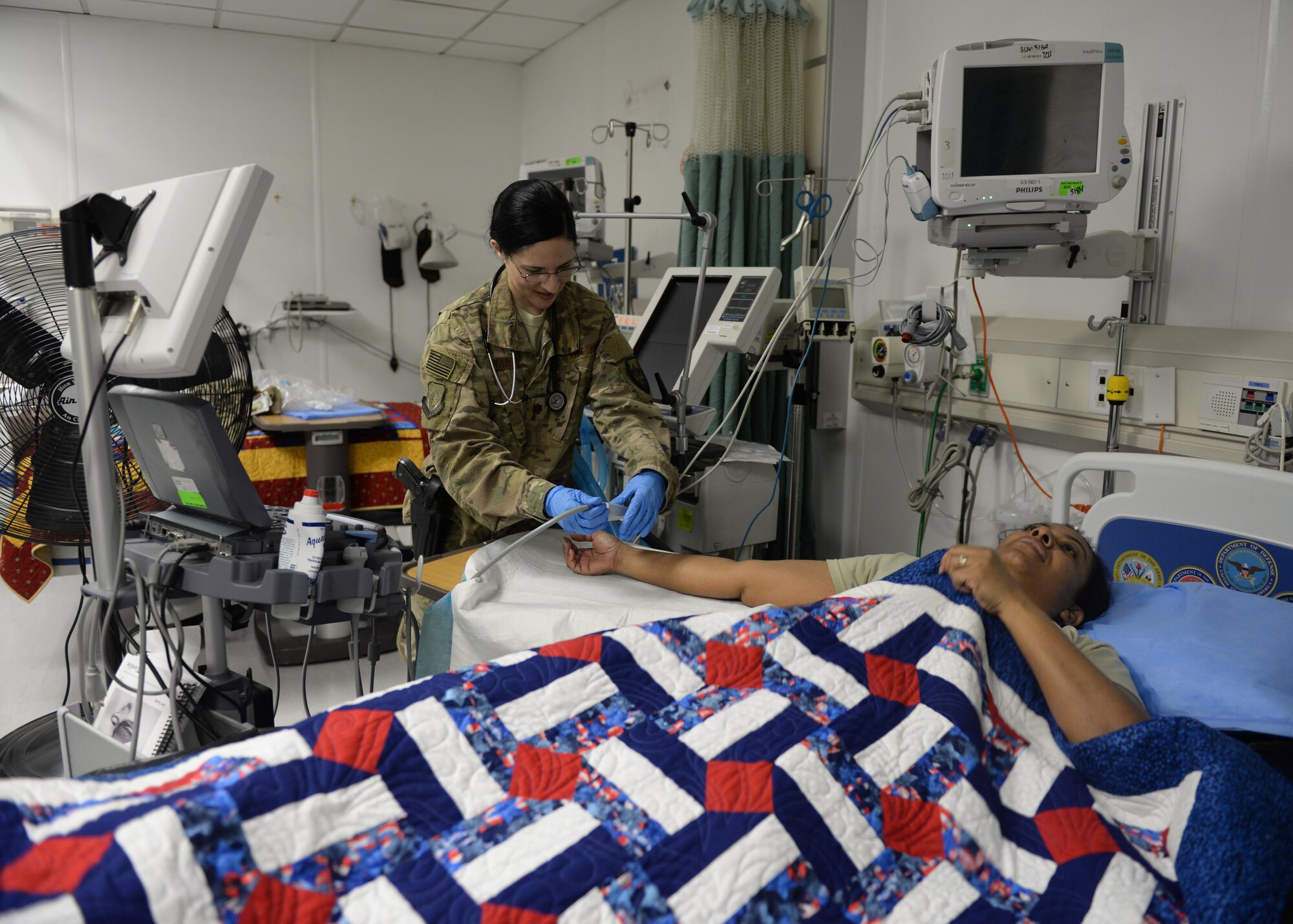 U.S. Air Force Maj. Anjeli Nayar, 455th Expeditionary Medical Operations Squadron intensive care unit general internist, simulates patient care on a hospital staff member Sept. 19, 2015, at Bagram Airfield, Afghanistan. Nayar is responsible for coordinating care for military members, defense civilians, civilian contractors, as well as some Afghan nationals, in the ICU at the Craig Joint Theater Hospital. (U.S. Air Force photo by Senior Airman Cierra Presentado/Released)