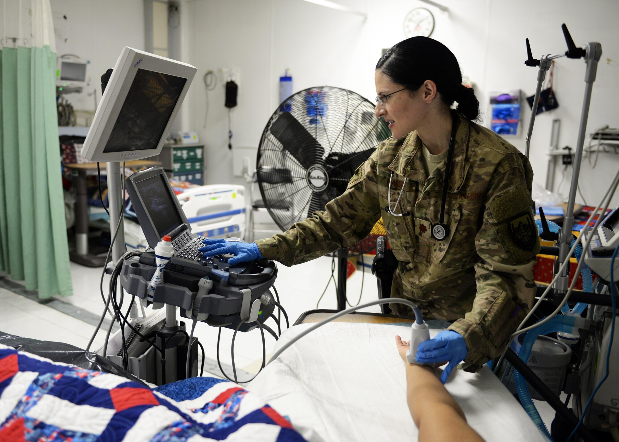 U.S. Air Force Maj. Anjeli Nayar, 455th Expeditionary Medical Operations Squadron intensive care unit general internist, simulates patient care on a hospital staff member Sept. 19, 2015, at Bagram Airfield, Afghanistan. Nayar is responsible for coordinating care for military members, defense civilians, civilian contractors, as well as some Afghan nationals, in the ICU at the Craig Joint Theater Hospital. (U.S. Air Force photo by Senior Airman Cierra Presentado/Released)