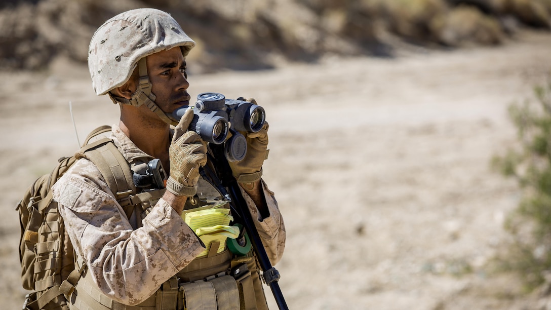 Sgt. Mitchell D. Taylor, explosive ordnance disposal technician, 3rd EOD, 9th Engineer Support Battalion, utilizes binoculars to scan an area for potential dangers during a post-blast analysis training scenario at Emerson Lake training area, Sept. 19, 2015. 3rd EOD encompassed a wide variety of training scenarios including cache scenarios, dismounted and mounted IED scenarios, along with a Tactical Recovery of Aircraft and Personnel scenario.