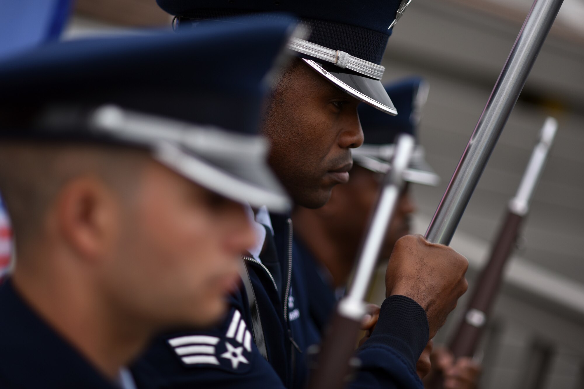 Senior Airmen Corey Smith, Dwayne Morgan and Dominic Surinaga, all members of the 106th Rescue Wing’s honor guard, take part in a memorial at Westhampton Beach for the Sept. 11, 2001, terrorist attacks. During this event, the honor guard displayed the colors and presented a folded American flag to Christine Dwyer, the sister of Army Pfc. Joseph Dwyer who died in 2008. Dwyer was featured in an iconic photo taken of him helping an Iraqi boy to safety. (U.S. Air Force photo/Staff Sgt. Christopher Muncy)