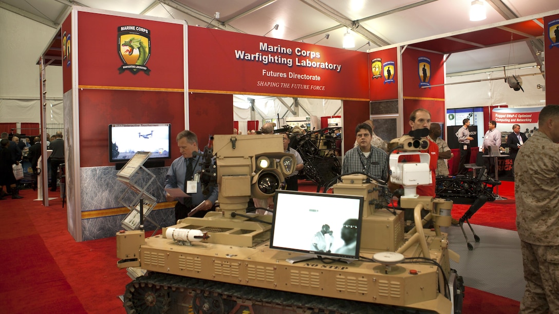 Marines and civilian guests tour the Marine Corps Warfighting Labratory booth at the 2015 Modern Day Marine Military Expo at Marine Corps Base Quantico, Va., Sept. 22, 2015. The expo is focusing on enhanced capabilities for expeditionary forces and is happening Sept. 22-24. 
