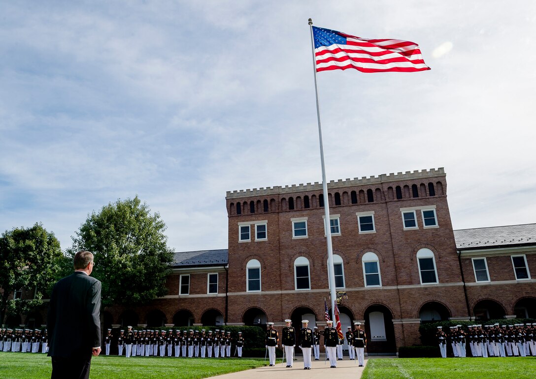 Defense Secretary Ash Carter stands while honors are played during the Marine Corps passage-of-command ceremony on Marine Barracks, Washington, D.C., Sept. 24, 2015.  Marine Corps Gen. Joseph F. Dunford relinquished command to Marine Corps  Gen. Robert B. Neller. Gen. Dunford will take over as Chairman of the Joint Chiefs of Staff. DoD photo by Army Staff Sgt. Sean K. Harp