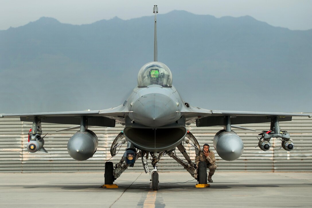 A U.S. airman and an F-16 Fighting Falcon pilot go over a pre-flight inspection before a combat sortie from Bagram Airfield, Afghanistan, Sept. 22, 2015. U.S. Air Force photo by Tech. Sgt. Joseph Swafford