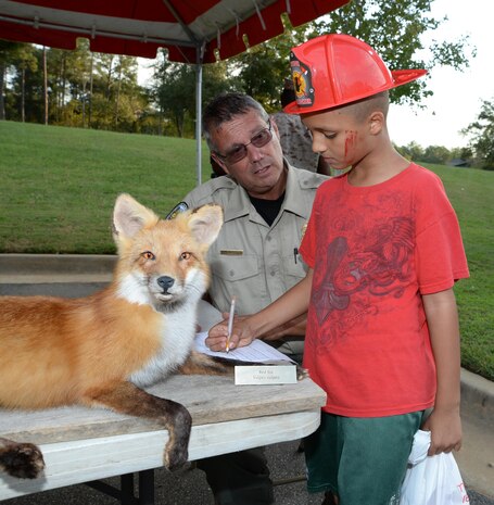 Al Belanger, game warden, Marine Corps Logistics Base Albany, discusses animal safety with a military family member at MCLB Albany's first emergency preparedness fair at the Lincoln Family Housing Community Center, Sept. 22.