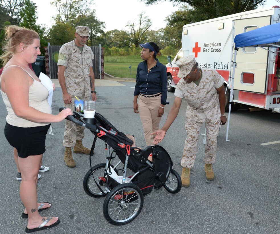 Staff Sgt. Michael T. Prescott Jr., small armorer repair technician, Weapons Systems Maintenance Center, Marine Corps Logistics Command, and his family attend Marine Corps Logistics Base Albany's first emergency preparedness fair at the  Lincoln Family Housing Community Center, Sept. 22. The Prescott family was greeted by Col. James C. Carroll III, commanding officer, MCLB Albany.