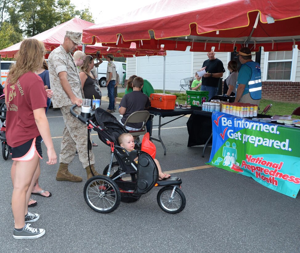 Staff Sgt. Michael T. Prescott Jr., small armorer repair technician, Weapons Systems Maintenance Center, Marine Corps Logistics Command, attends Marine Corps Logistics Base Albany's first emergency preparedness fair with his family at the Lincoln Family Housing Community Center, Sept. 22.