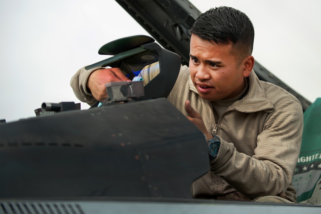 U.S. Air Force Airman 1st Class Jay Chhoeun cleans the screen on an F-16 Fighting Falcon aircraft on Bagram Airfield, Afghanistan, Sept. 22, 2015. Chhoeun is assigned to the 455th Expeditionary Maintenance Squadron. U.S. Air Force photo by Tech. Sgt. Joseph Swafford