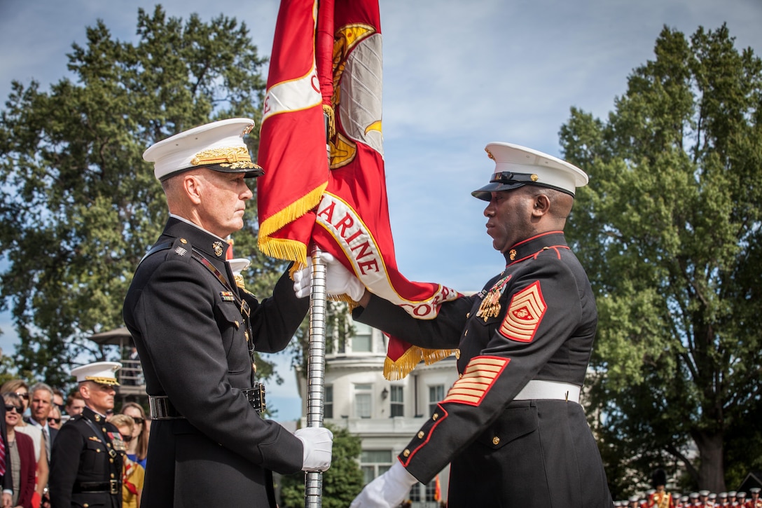 The 18th Sergeant Major of the Marine Corps, Ronald L. Green, right, delivers the Battle Colors to the 36th Commandant of the Marine Corps, Gen. Joseph F. Dunford Jr., at Marine Barracks Washington, D.C., Sept. 24, 2015. Gen. Robert B. Neller took command from Dunford during the Passage of Command Ceremony. (U.S. Marine Corps photo by Sgt. Melissa Marnell, Office of the Sergeant Major of the Marine Corps/Released)