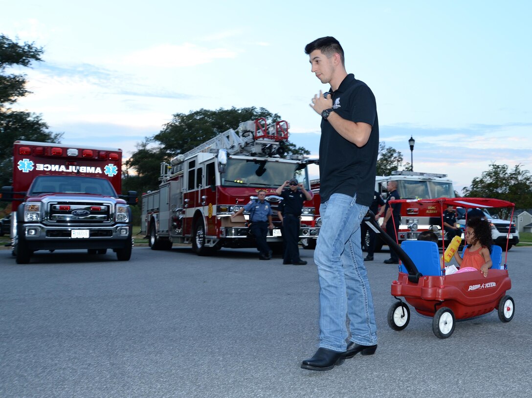 Cpl. Philip Mason with General Account and Reparable Issue Point, Supply Branch, Marine Forces Reserve G-4, pulls his children in a wagon as he visits each exhibit at Marine Corps Logistics Base Albany's first emergency preparedness fair at the Lincoln Family Housing Community Center, Sept. 22.