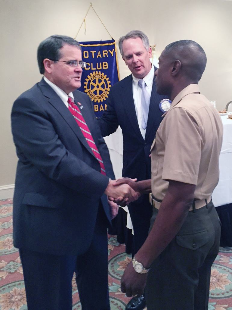 Col. James C. Carroll III, commanding officer, Marine Corps Logistics Base Albany, visits the Albany Rotary Club during lunch at Doublegate Country Club, Albany, Ga., Sept. 24, as a guest of longtime member, Dr. John Culbreath, former superintendent, Dougherty County School System. Carroll greeted program speaker Dr. Jere Morehead, president, University of Georgia and Vic Sullivan, president, Albany Rotary Club. According to Culbreath, the Albany Rotary Club is a part of a world-wide civic and service organization. Locally, the organization funds literacy programs, United Way and other organizations.  "We also give scholarships to outstanding graduates from all public and private high schools in Dougherty County,” Culbreath said. “It was my pleasure to have the Marine base represented today and I'm giving them an open invitation for future visits."