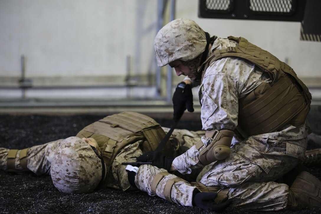 A Marine with 2nd Supply Battalion, Combat Logistics Regiment 25, applies a tourniquet to a simulated casualty at Camp Lejeune, N.C., Sept. 23, 2015. The battalion conducted the training, which simulates vehicle rollovers and how to react, in order to hone their skills prior to deploying. (U.S. Marine Corps photo by Cpl. Paul S. Martinez/Released)