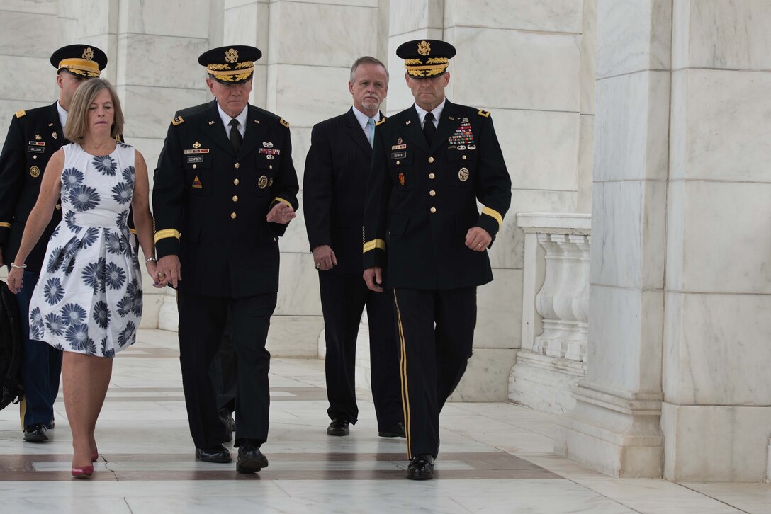 Army Gen. Martin E. Dempsey, chairman of the Joint Chiefs of Staff, and his wife, Deanie, walk at Arlington National Cemetery in Arlington, Va., Sept. 25, 2015. Dempsey visited the cemetery to lay a wreath in honor of unknown service members as he prepared to retire after 41 years of service. U.S. Army photo by Spc. Cody W. Torkelson