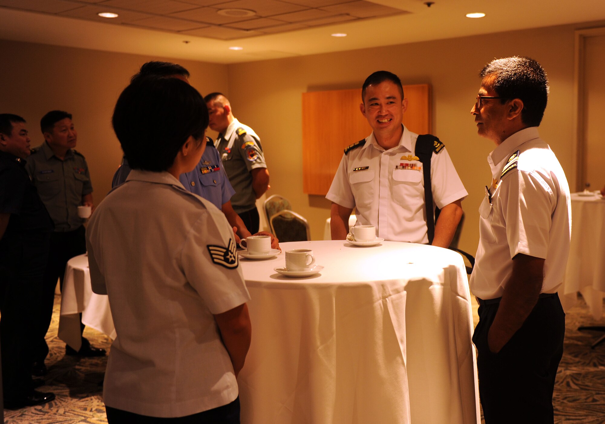 U.S. and multinational airmen speak with each other during a break in discussion sessions at the Pacific Rim Airpower Symposium Sept. 22, 2015, in Honolulu, Hawaii. Senior officer and enlisted airmen from nations throughout the Indo-Asia-Pacific region attended the symposium to discuss ways to improve cooperation, leadership and coordination efforts. (U.S. Air Force photo by Staff Sgt. Alexander Martinez/Released)