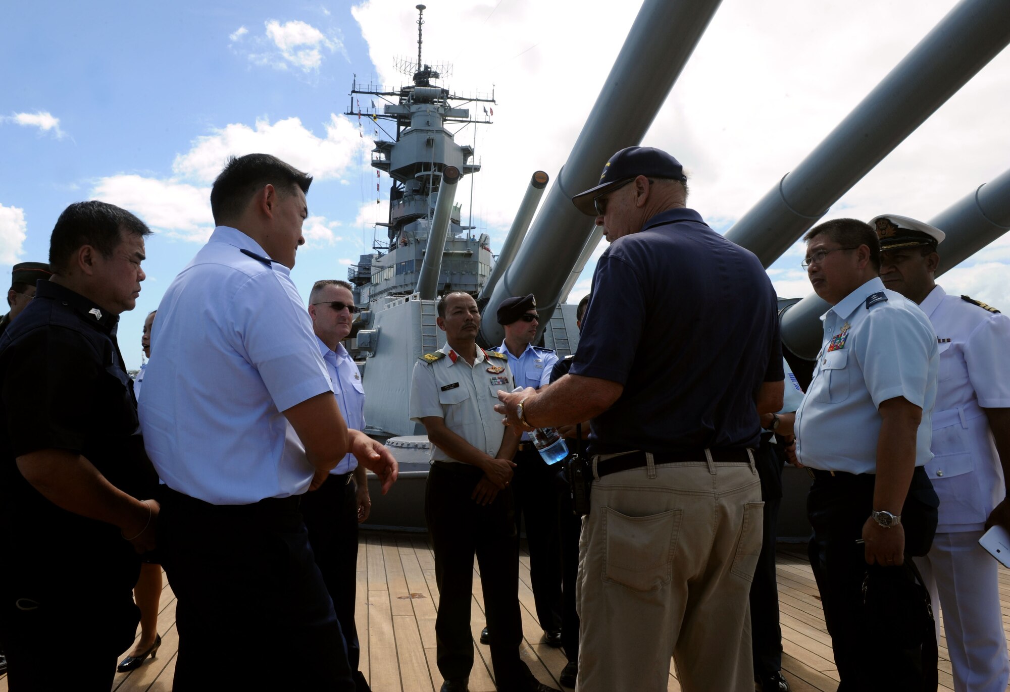 Pacific Rim Airpower Symposium attendees listen to a tour guide aboard the USS Battleship Missouri Memorial during a tour of Pearl Harbor historic sites Sept. 22, 2015, in Honolulu, Hawaii. Senior officer and enlisted airmen from nations throughout the Indo-Asia-Pacific region attended the symposium to discuss ways to improve cooperation, leadership and coordination efforts. (U.S. Air Force photo by Staff Sgt. Alexander Martinez/Released)