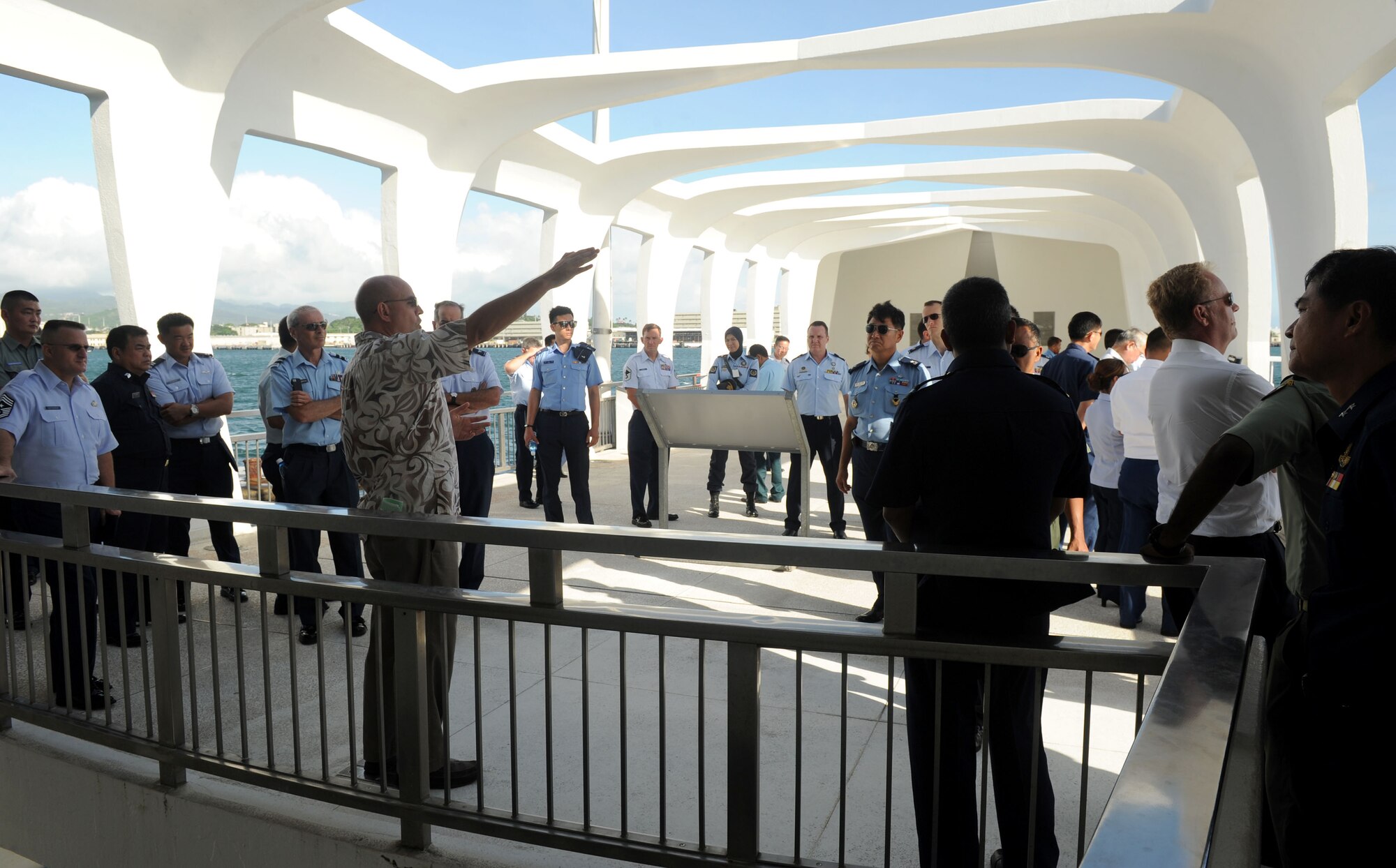 Pacific Rim Airpower Symposium attendees listen to a tour guide aboard the WWII Valor in the Pacific National Monument during a tour of Pearl Harbor historic sites Sept. 22, 2015, in Honolulu, Hawaii. Senior officer and enlisted airmen from nations throughout the Indo-Asia-Pacific region attended the symposium to discuss ways to improve cooperation, leadership and coordination efforts. (U.S. Air Force photo by Staff Sgt. Alexander Martinez/Released)