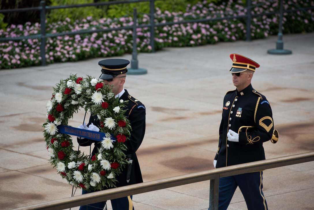 A military honor guard member carries a wreath during a ceremony at Arlington National Cemetery in Arlington, Va., Sept. 25, 2015. During the ceremony, Army Gen. Martin E. Dempsey, chairman of the Joint Chiefs of Staff, placed the wreath at the Tomb of the Unknown Soldier as he prepared to retire after 41 years of service. U.S. Army photo by Spc. Cody W. Torkelson