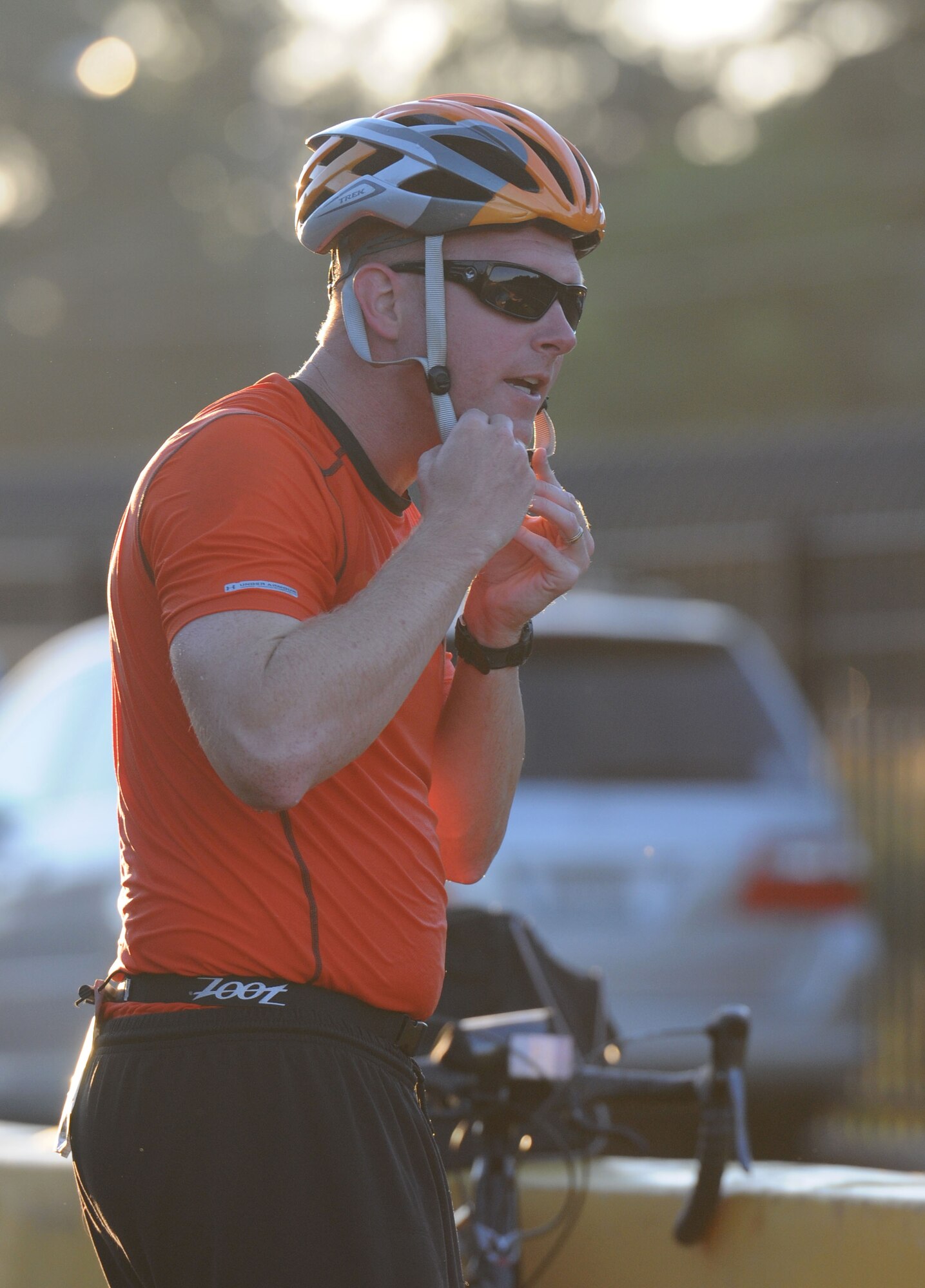 Master Sgt. Ryan Carlisle, 81st Training Support Squadron, fastens his bicycle helmet as he transitions from the swim event to the bike event during Keesler’s mini-triathlon Sept. 25, 2015, Keesler Air Force Base, Miss. The event included a 200-yard swim, 9-mile bike ride and a 2-mile run. (U.S. Air Force photo by Kemberly Groue)