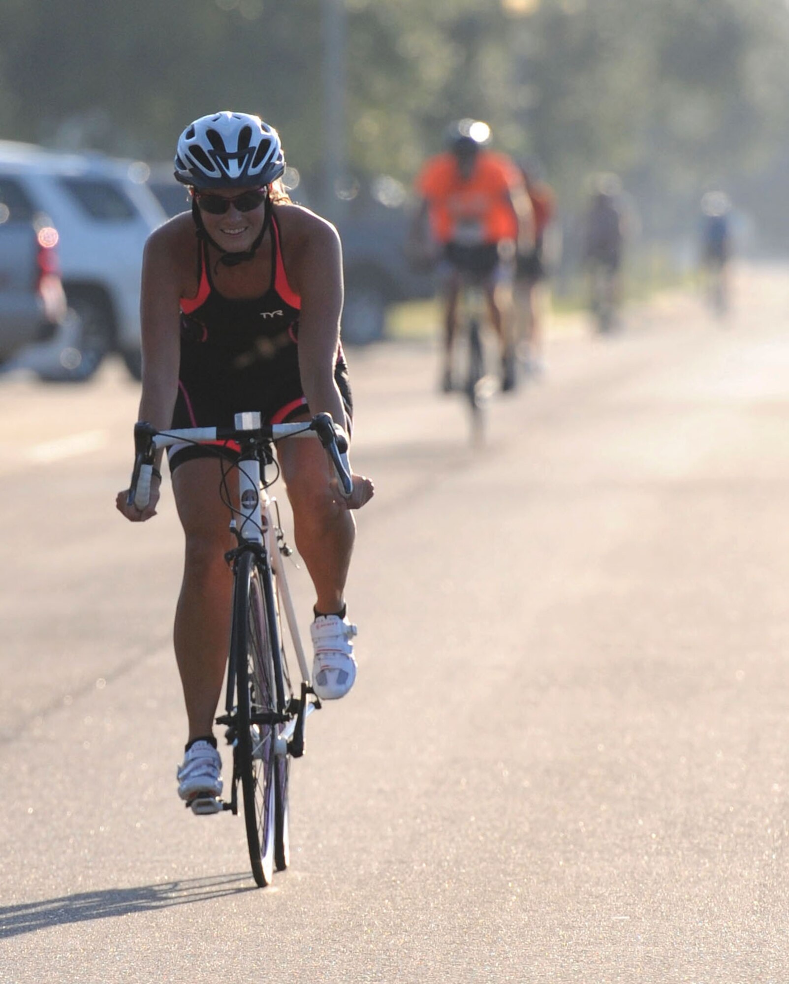 Camille Moberg, spouse of Maj. Matthew Moberg, 81st Dental Squadron, cycles around the 9-mile bike course during Keesler's mini-triathlon Sept. 25, 2015, Keesler Air Force Base, Miss. The event also included a 2-mile run and a 200-yard swim. (U.S. Air Force photo by Kemberly Groue)