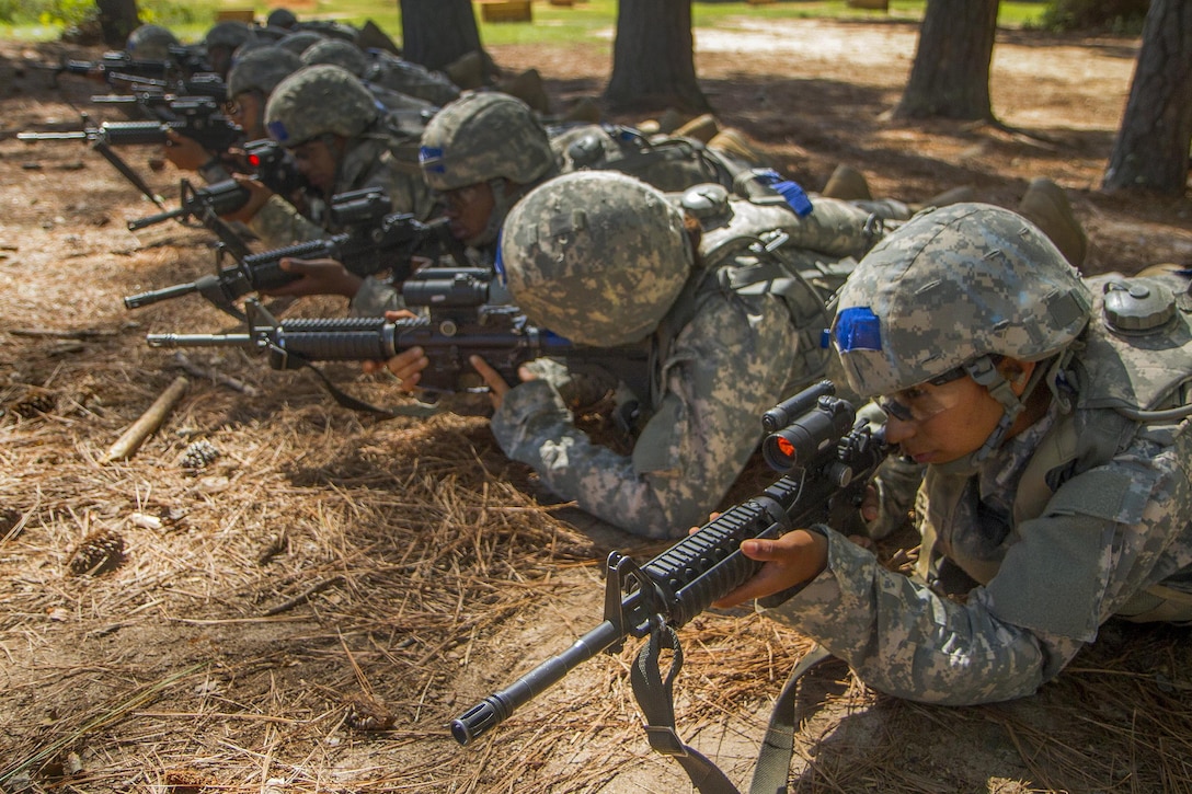 Soldiers lay in prone positions while they wait to move through a buddy team live-fire range during basic training at Fort Jackson, S.C., Sept. 19, 2015. U.S. Army photo by Sgt. Ken Scar