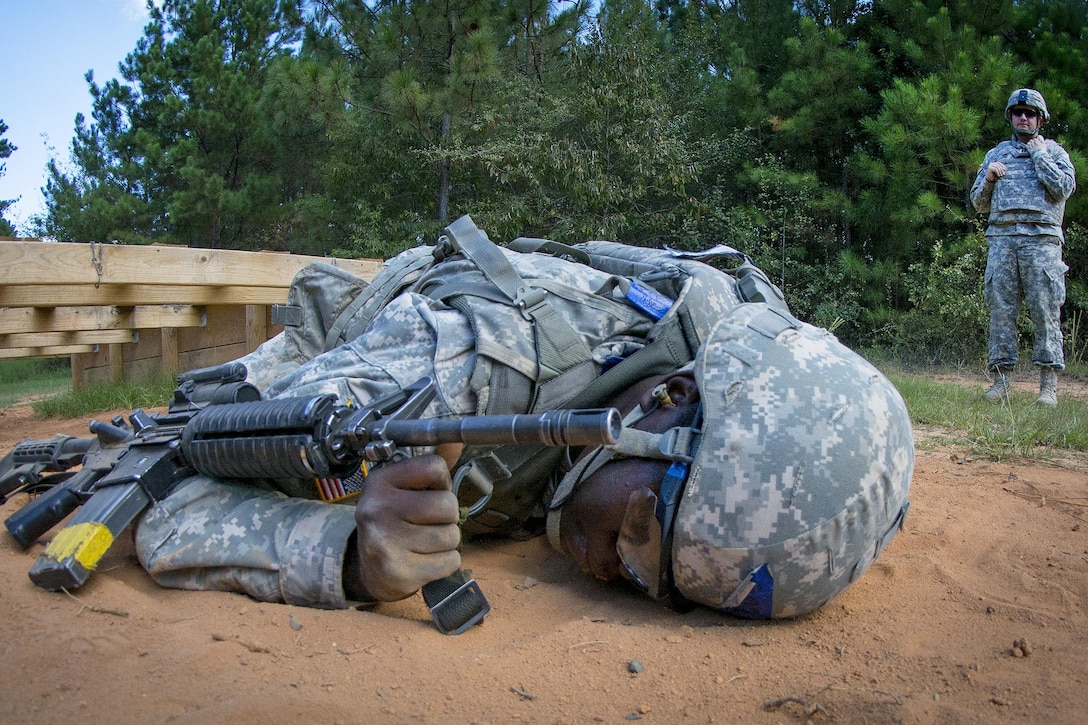 Army Pvt. Emily Karns crawls through a buddy team live-fire course during basic training at Fort Jackson, S.C., Sept. 19, 2015. U.S. Army photo by Sgt. Ken Scar
